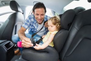 dad setting car seat