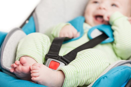 happy infant in car seat